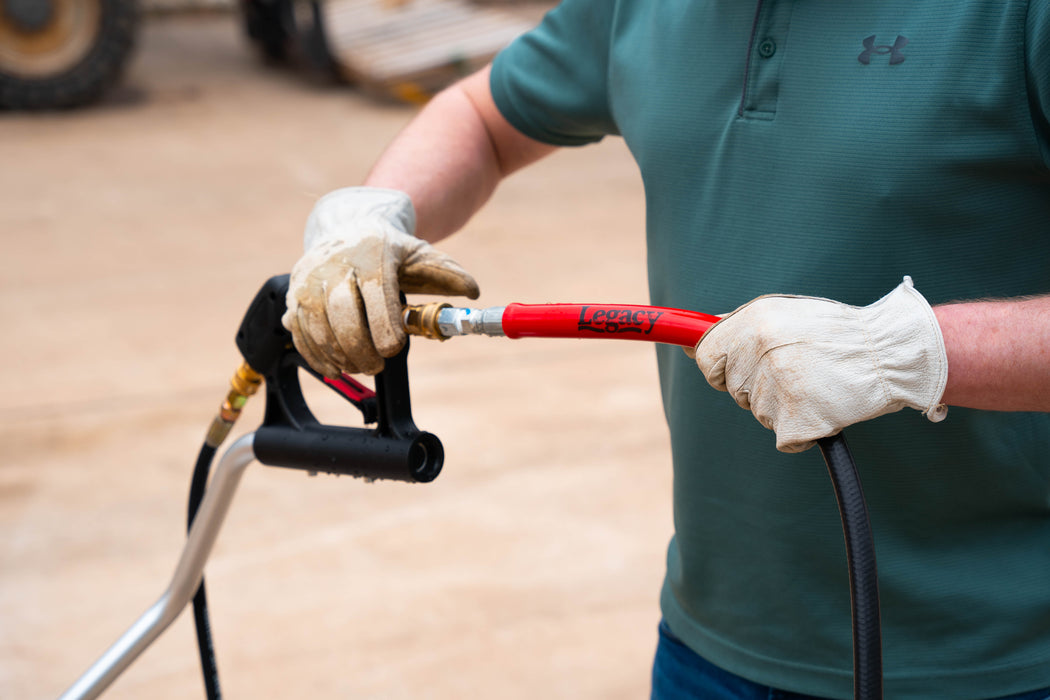 Man's attaching Legacy hose to surface cleaner